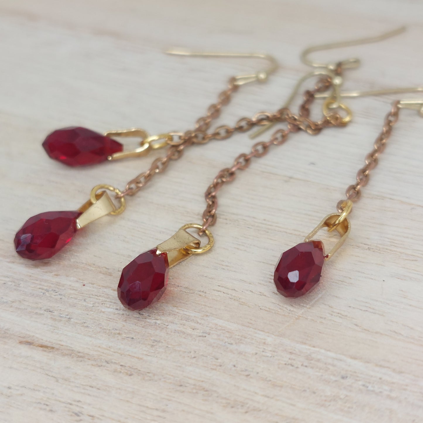 Blood Drop Earring. Silver chain, a single faceted Red crystal. Sold as a single or a pair. Various lengths. Available in gold or silver.