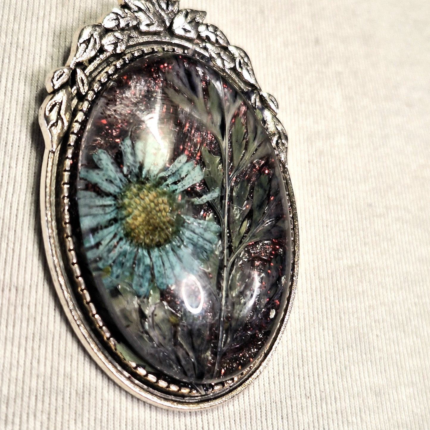 Delicate Goth Girl Pendant Necklace with blue daisy flower in an ornate silver statement frame. Handmade. One-of-a-kind.