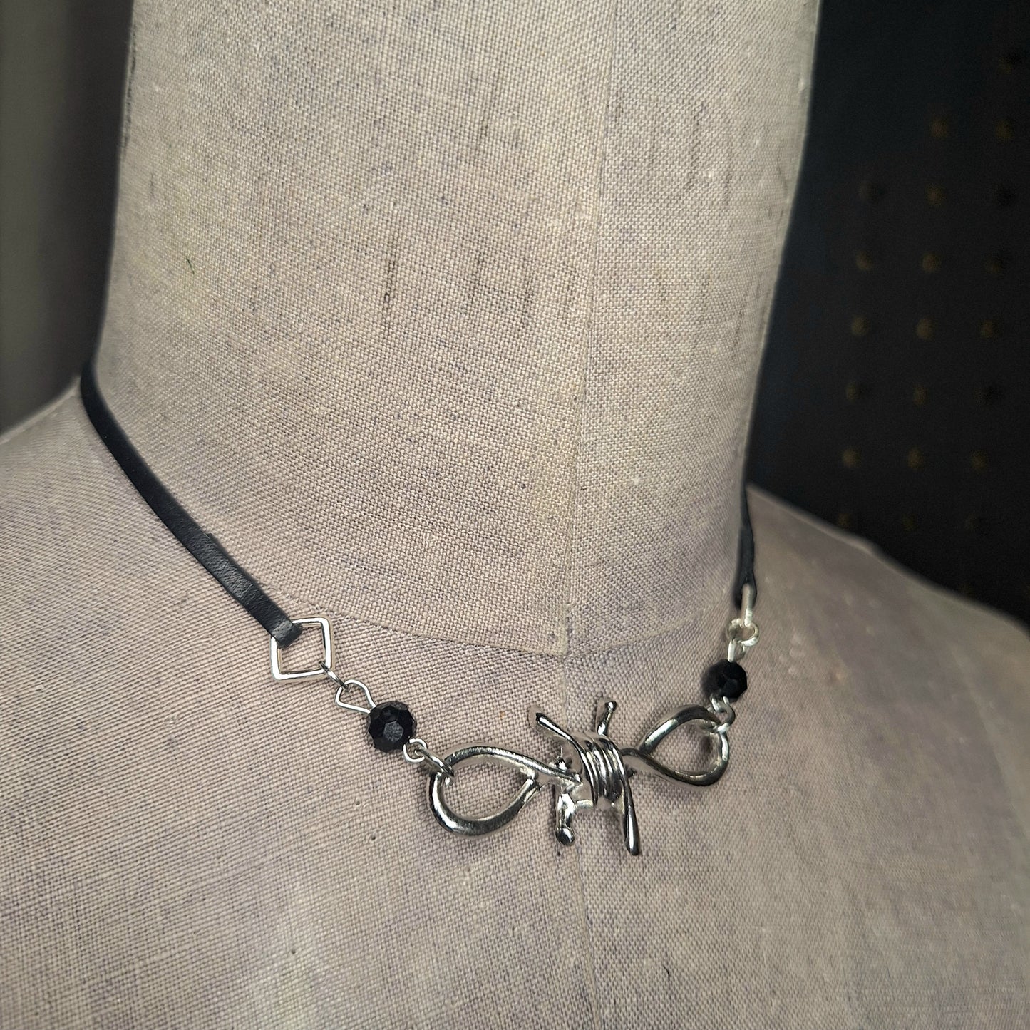 Silver Barbed Wire Bow and leather ribbon necklace. Handmade. Sophisticated Goth.