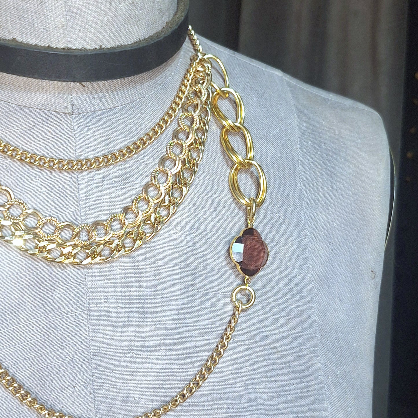 Having a Gold Moment! A multi gold chain statement necklace. Assymmetrical handmade gold chain piece with a stunning faceted amethyst stone.