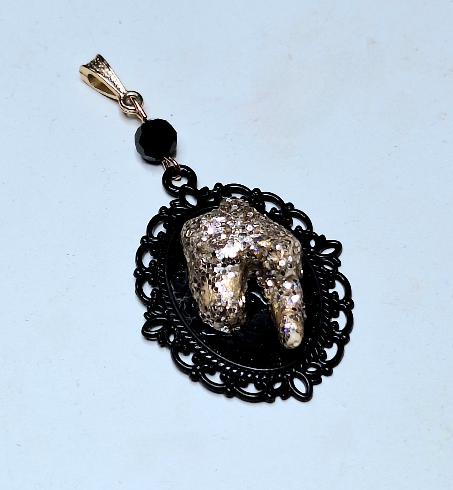 Gold bling tooth pendant. Real coyote tooth, on black ornate frame. Gold bail and black crystal.