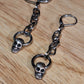 Silver skull mini door knocker and chain dangle earrings.