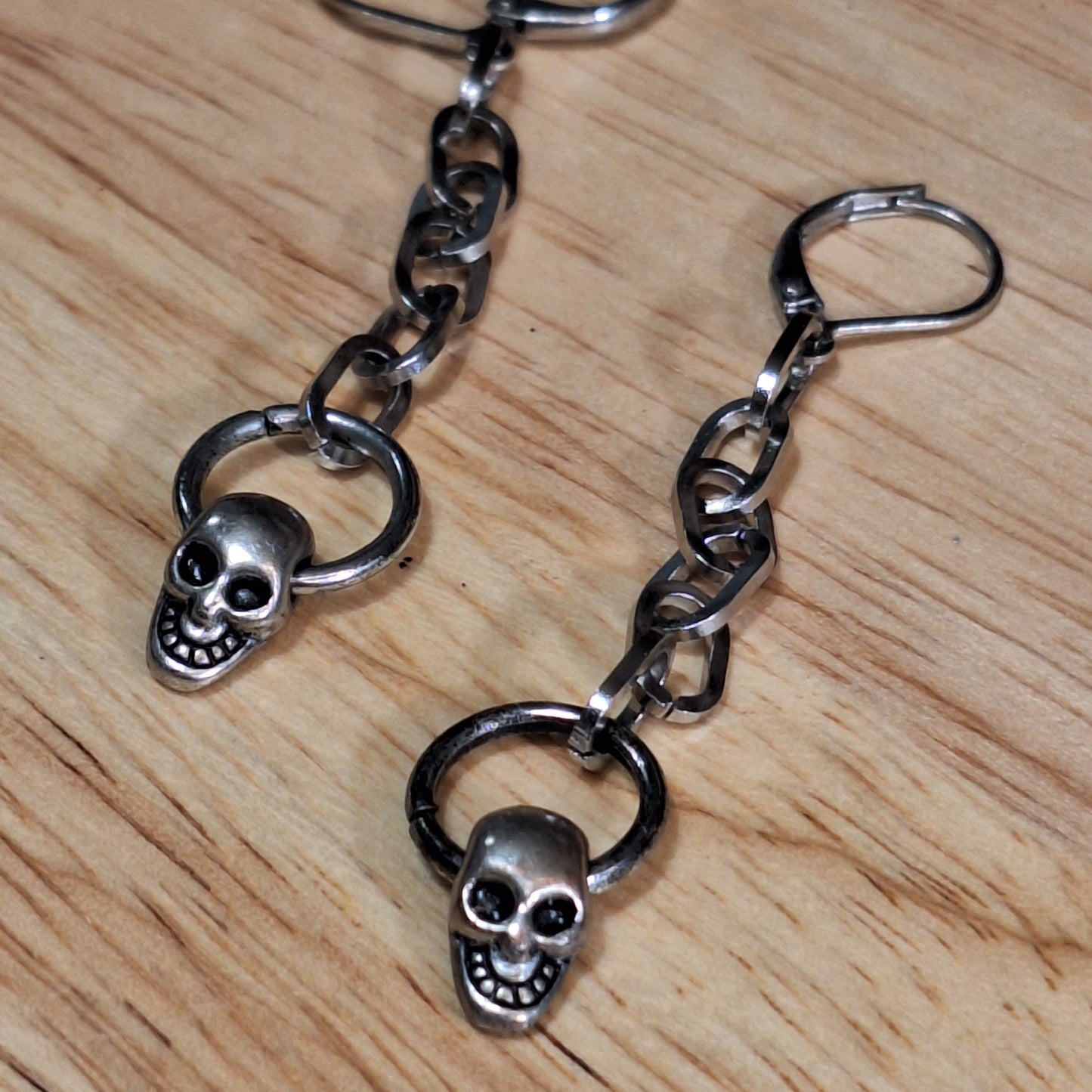 Silver skull mini door knocker and chain dangle earrings.