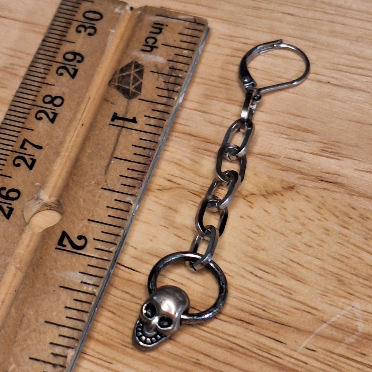 Silver skull mini door knocker and chain dangle earrings.