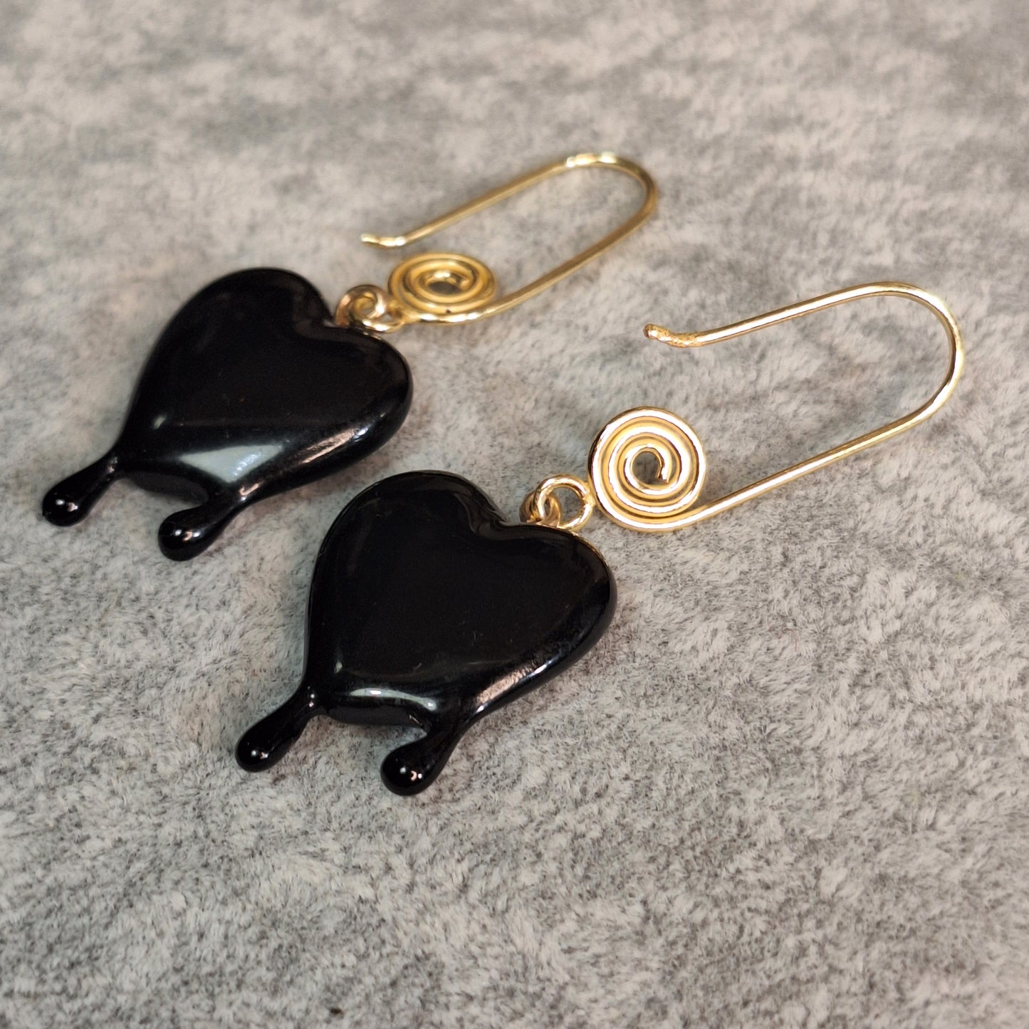 Black dripping heart and gold swirl hook earrings.