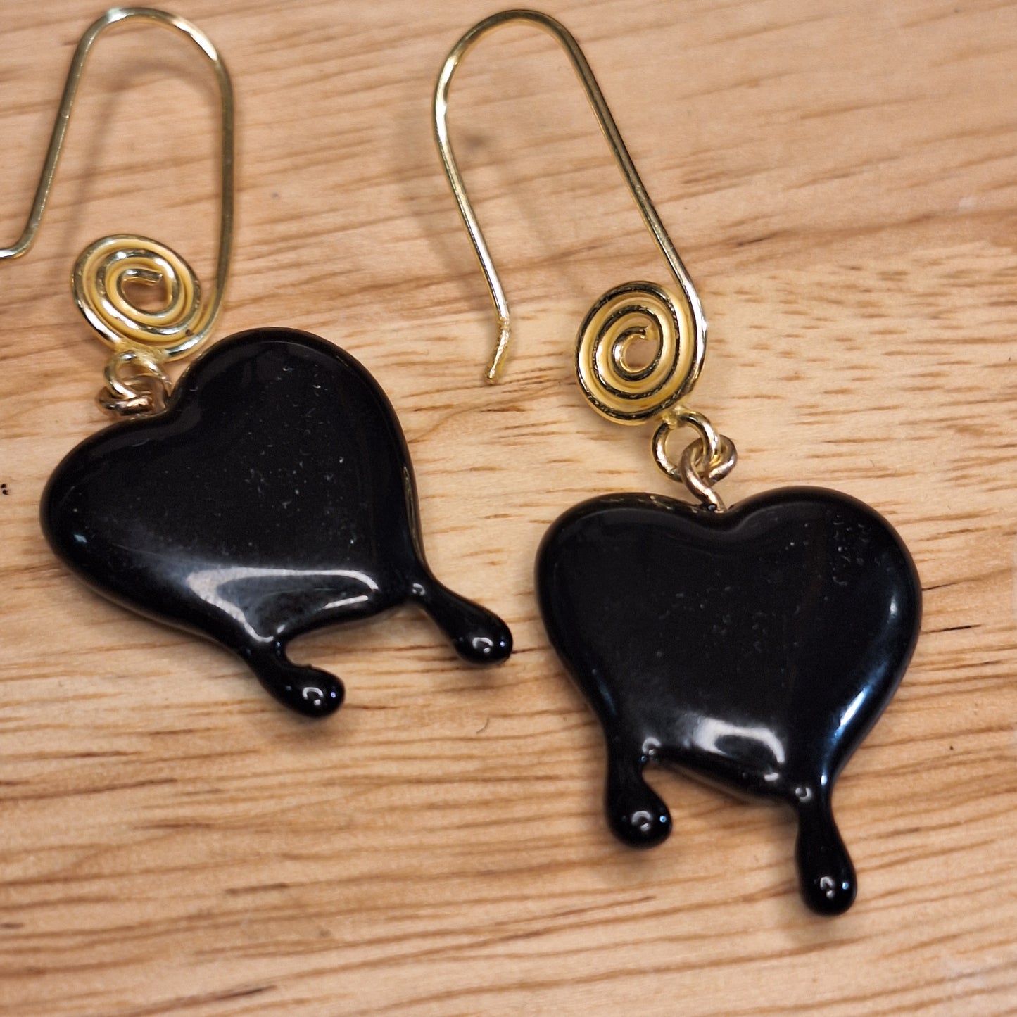 Black dripping heart and gold swirl hook earrings.