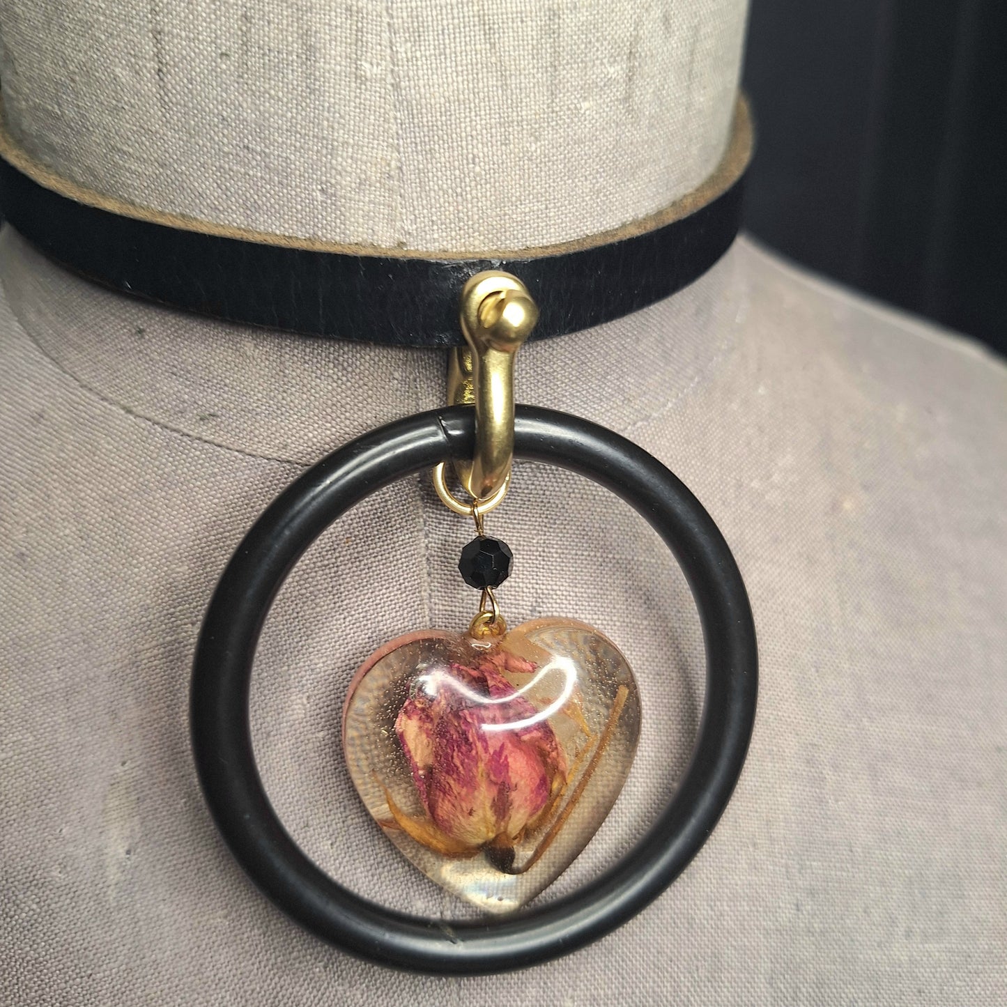 The Deadly Rose. Chic leather necklace with a single pink dried rosebud in a resin heart pendant.