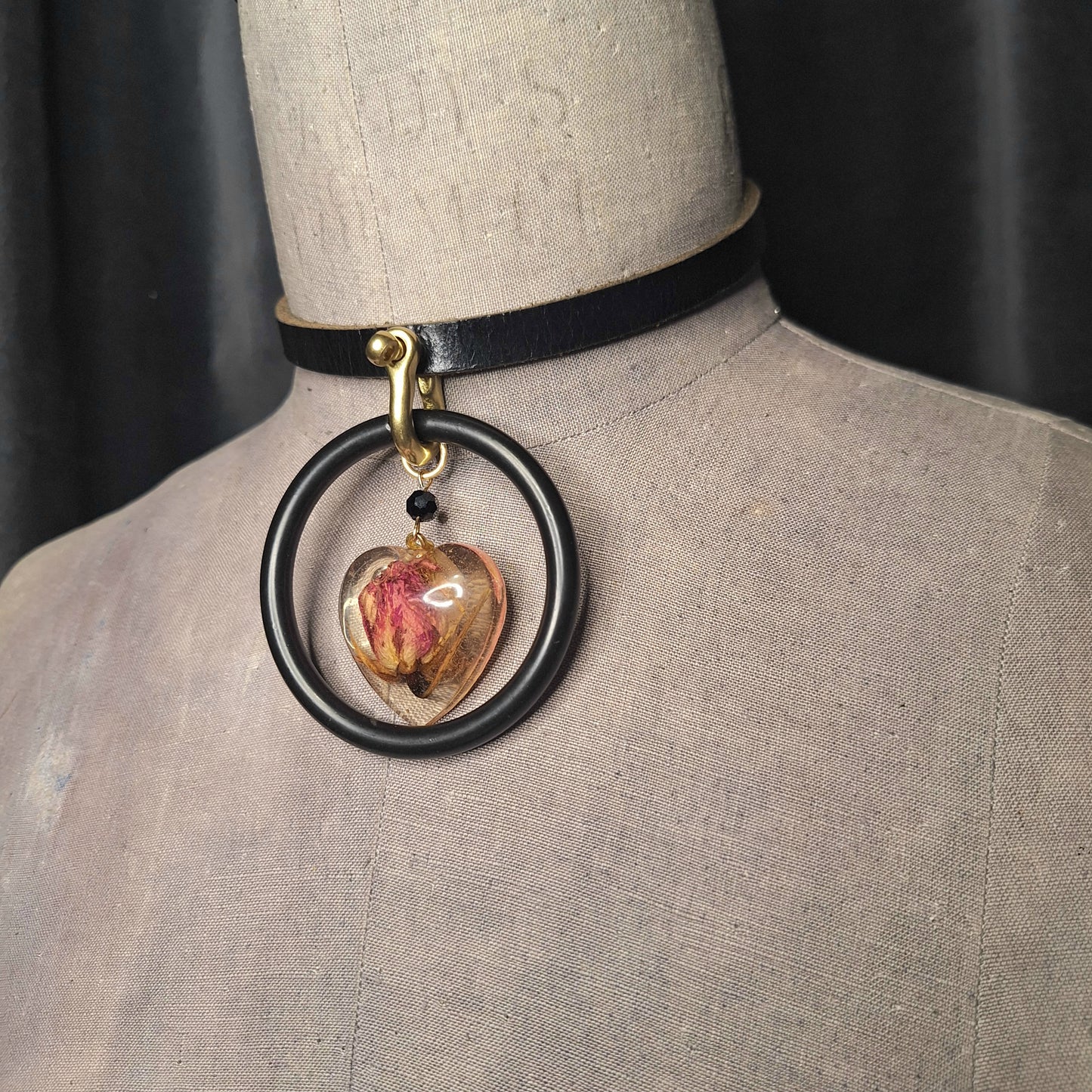 The Deadly Rose. Chic leather necklace with a single pink dried rosebud in a resin heart pendant.