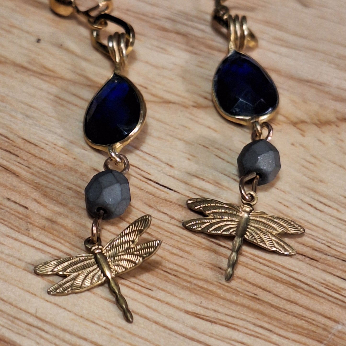Antique gold dragonfly charm and blue sapphire art deco earrings.