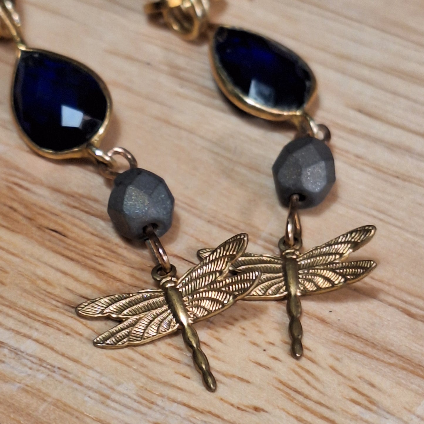 Antique gold dragonfly charm and blue sapphire art deco earrings.