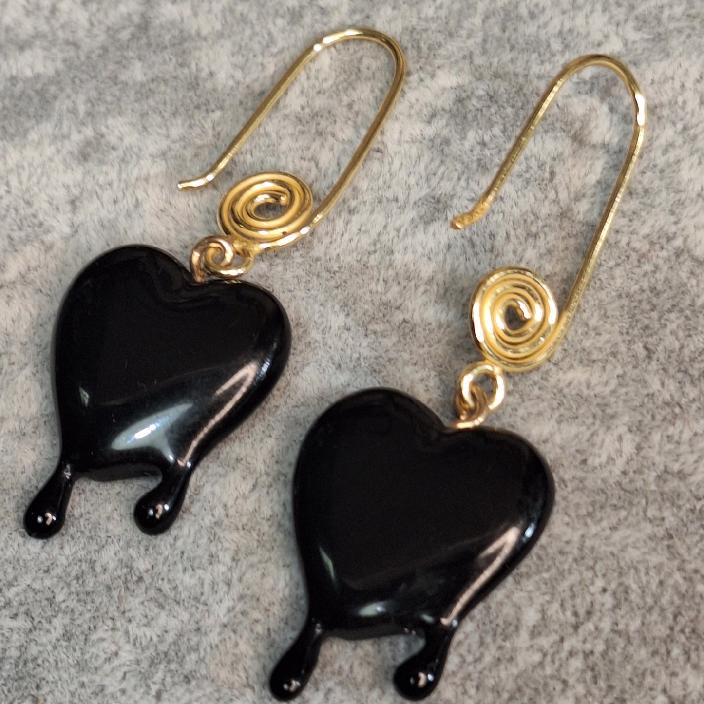Black dripping heart and gold swirl hook earrings.