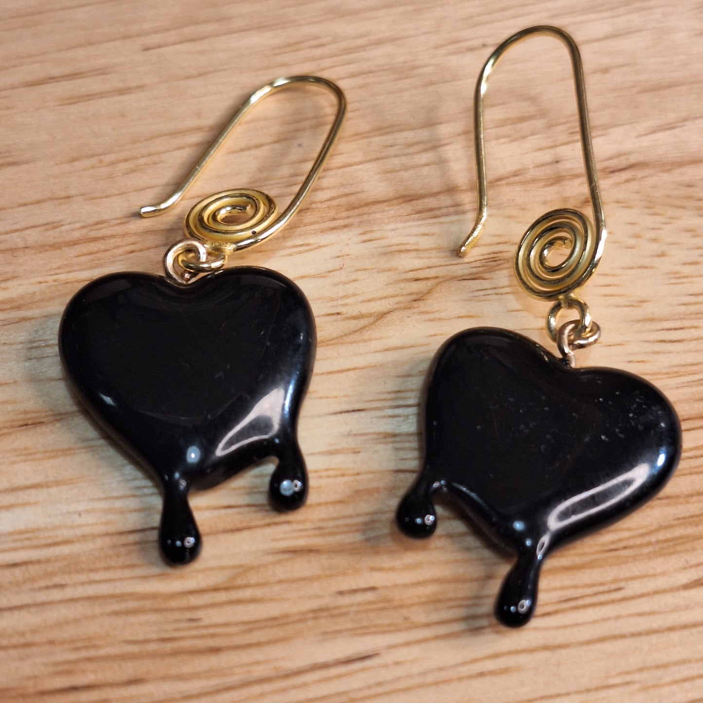 Black dripping heart and gold swirl hook earrings.