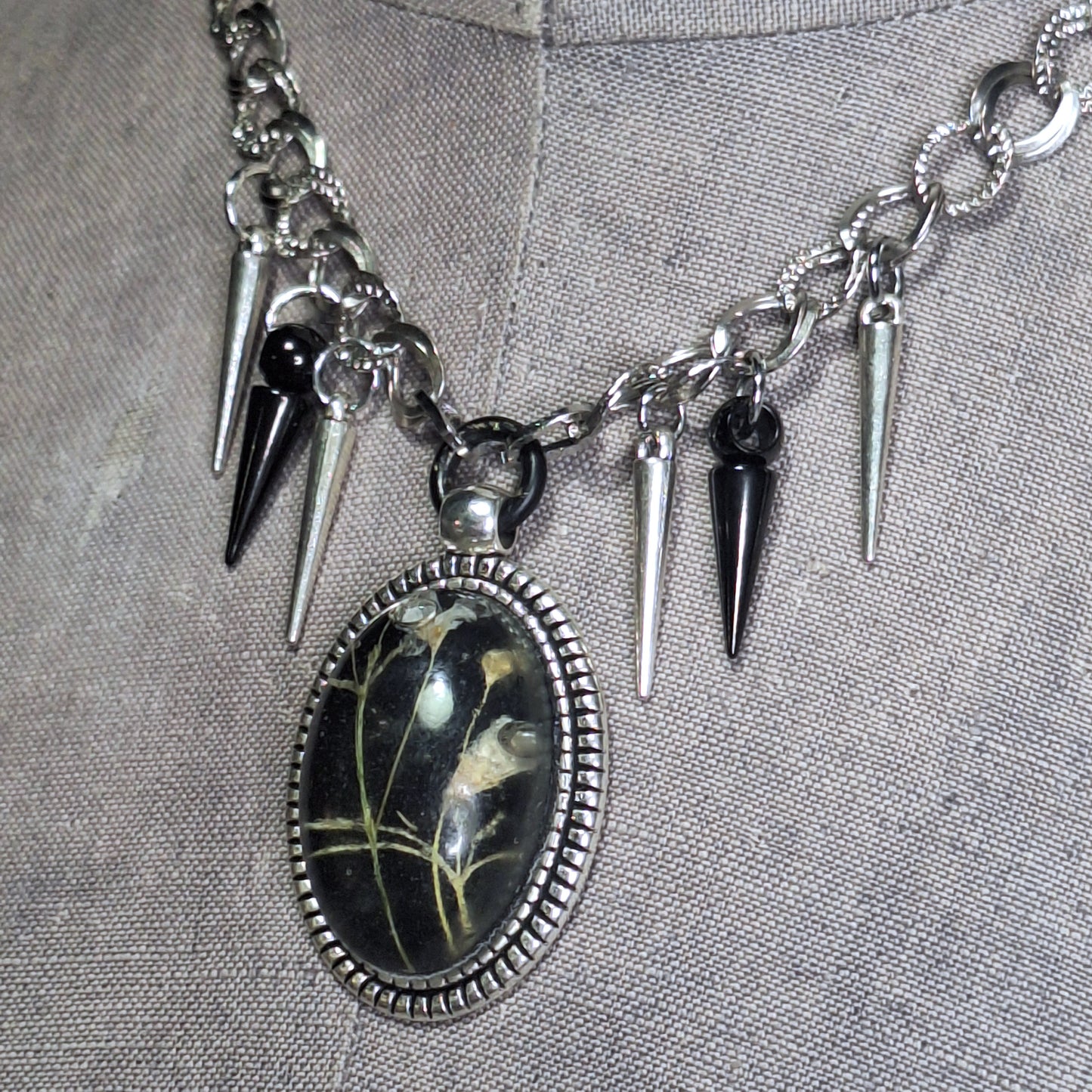 Thorny Weather. Real flower cameo pendant with a side of spikes.