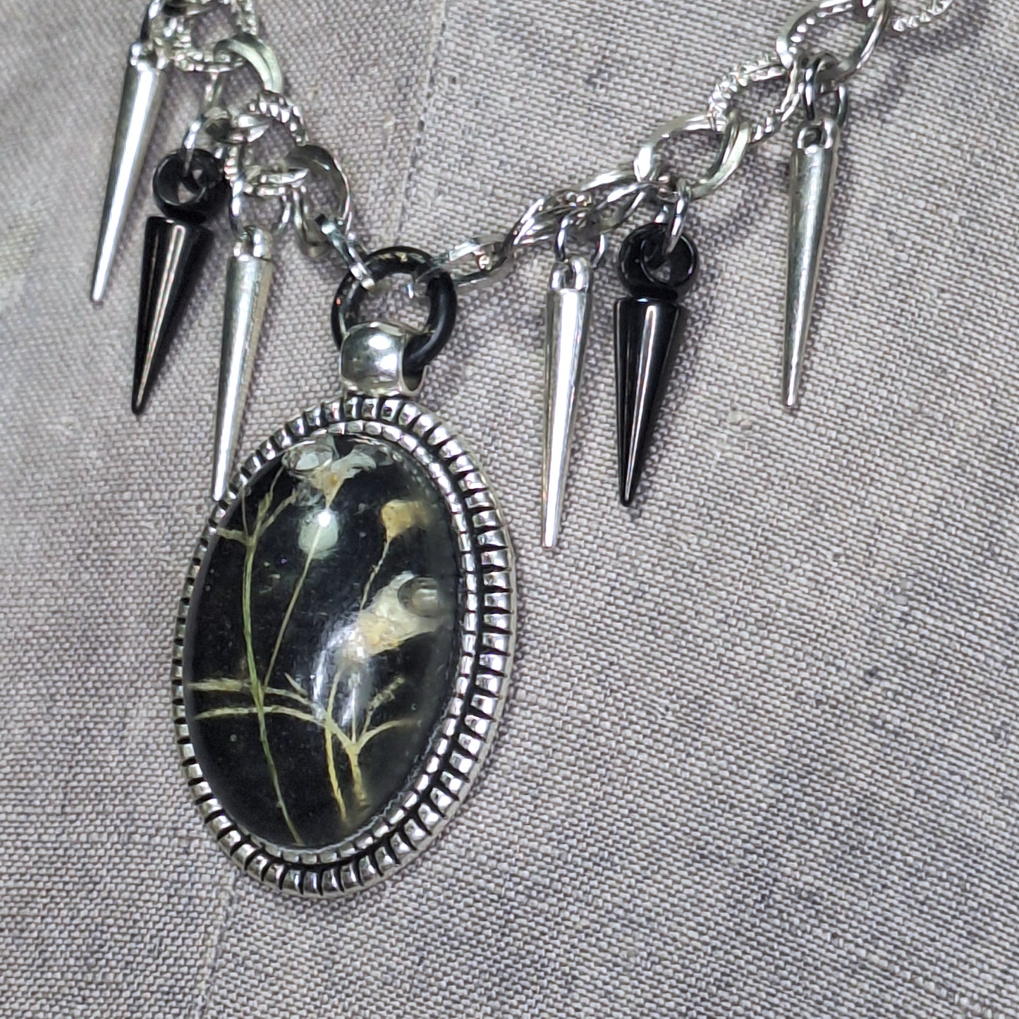 Thorny Weather. Real flower cameo pendant with a side of spikes.