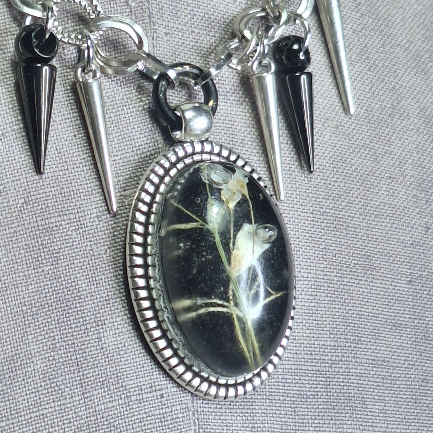 Thorny Weather. Real flower cameo pendant with a side of spikes.