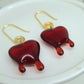 Red dripping heart and gold swirl hook earrings.
