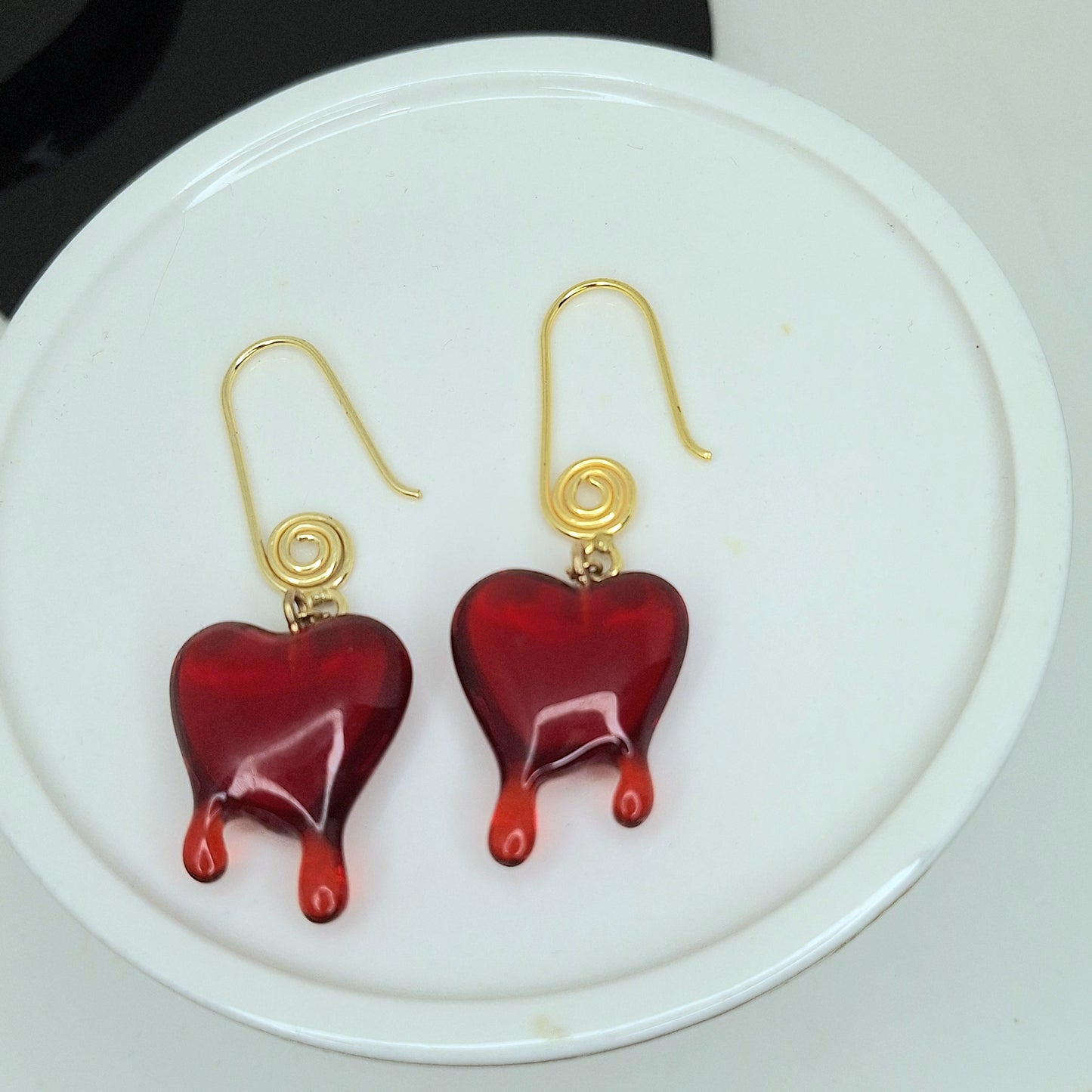 Red dripping heart and gold swirl hook earrings.