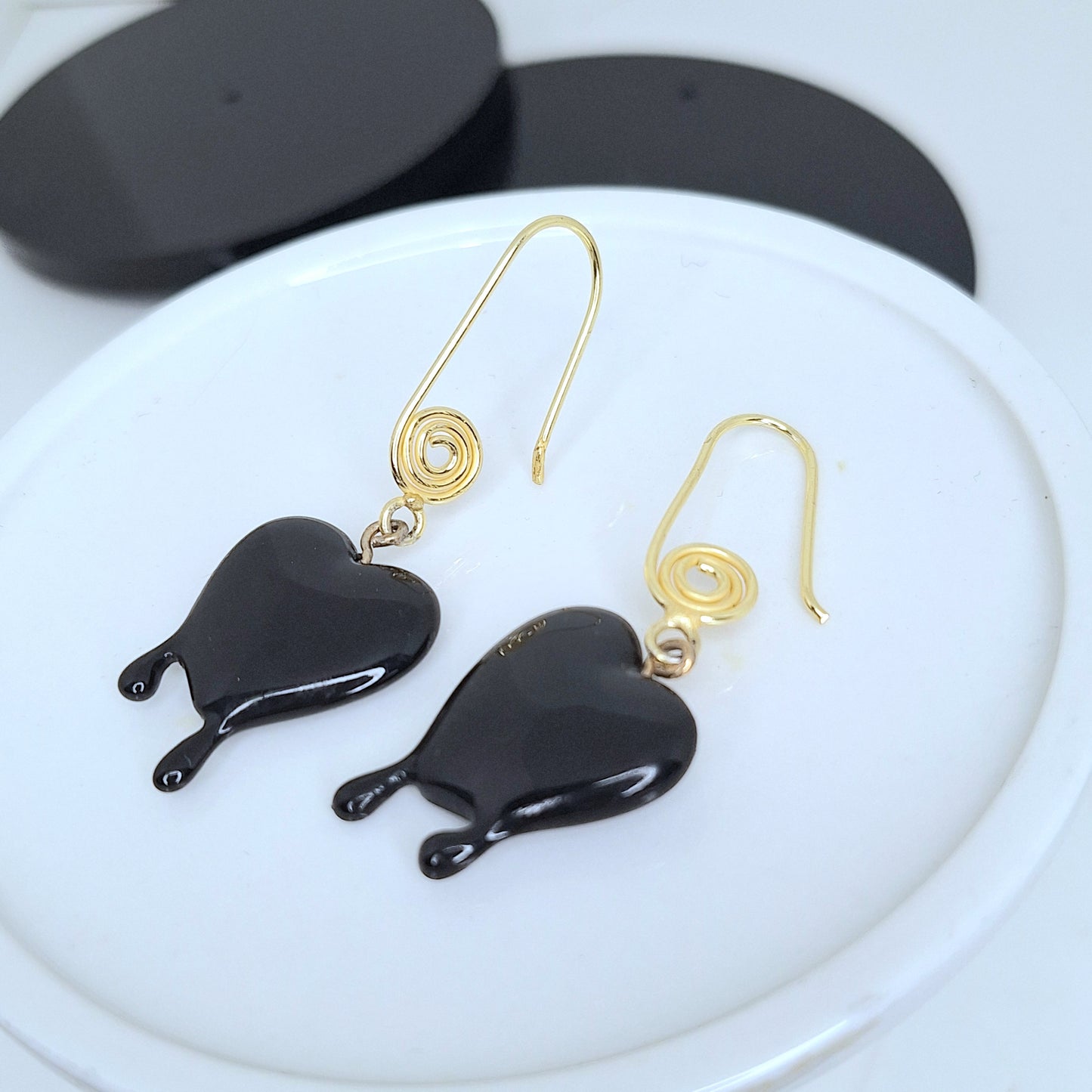 Black dripping heart and gold swirl hook earrings.