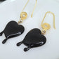 Black dripping heart and gold swirl hook earrings.