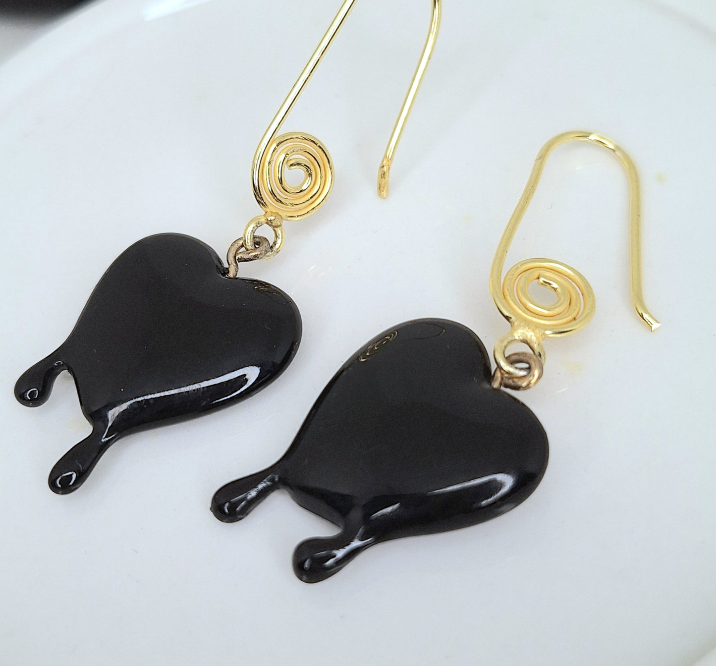 Black dripping heart and gold swirl hook earrings.