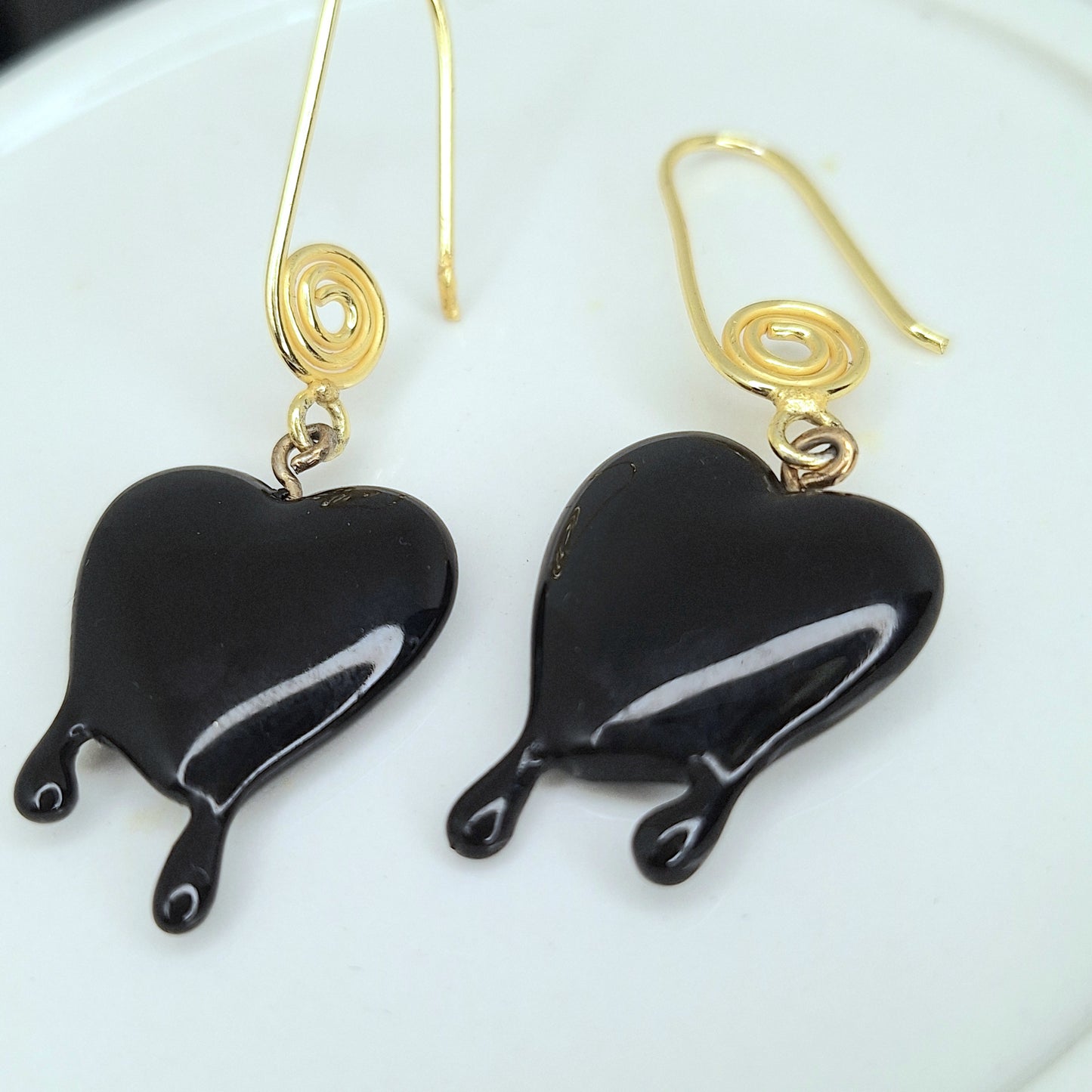 Black dripping heart and gold swirl hook earrings.