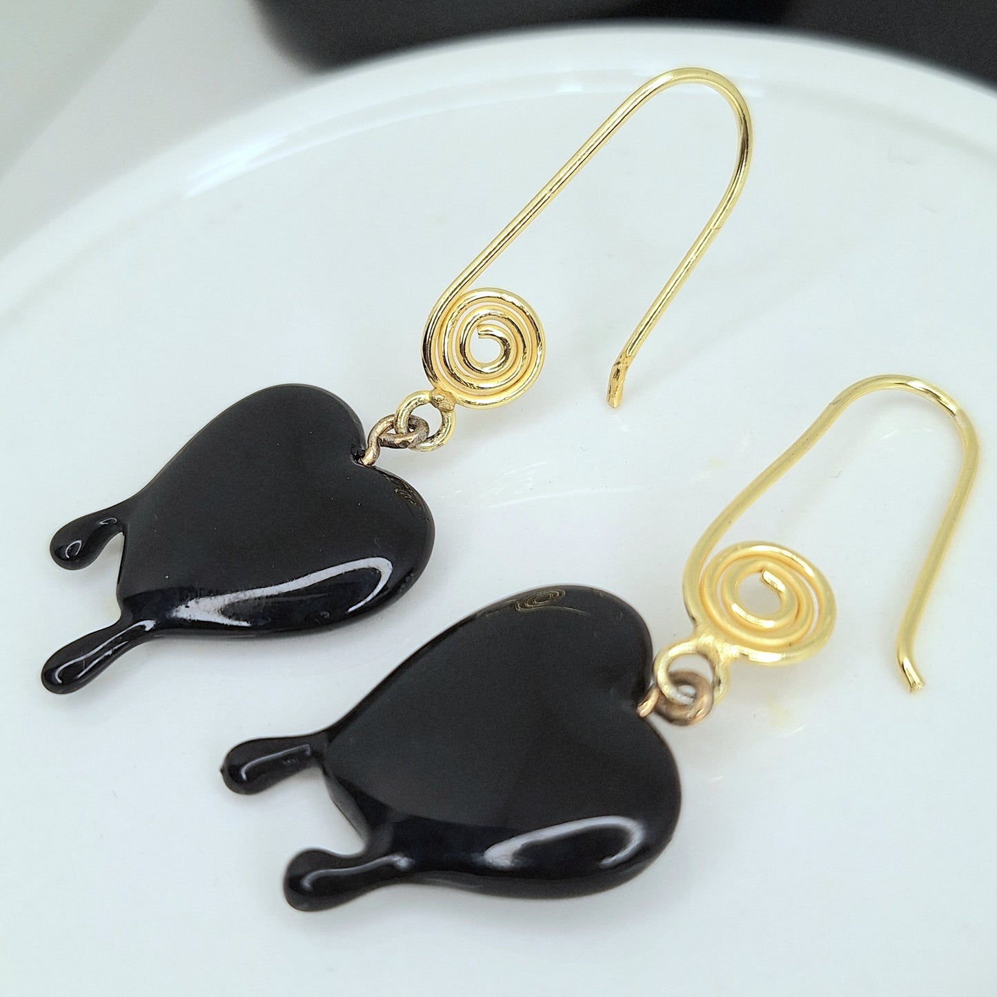 Black dripping heart and gold swirl hook earrings.