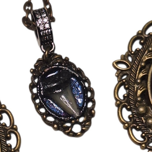 Tiny shark tooth cameo necklace. Antique layers framing. Iridescent blue backdrop.