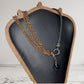 Leather and multi copper chain asymmetrical necklace. Mini silver carabiner with black teardrop crystal.