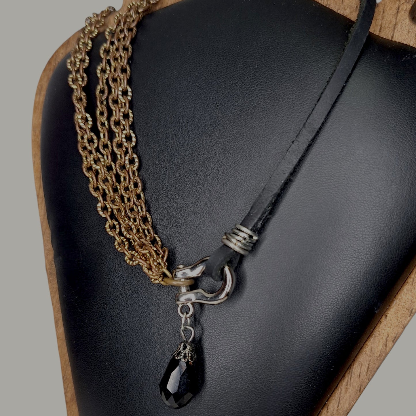 Leather and multi copper chain asymmetrical necklace. Mini silver carabiner with black teardrop crystal.