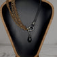 Leather and multi copper chain asymmetrical necklace. Mini silver carabiner with black teardrop crystal.