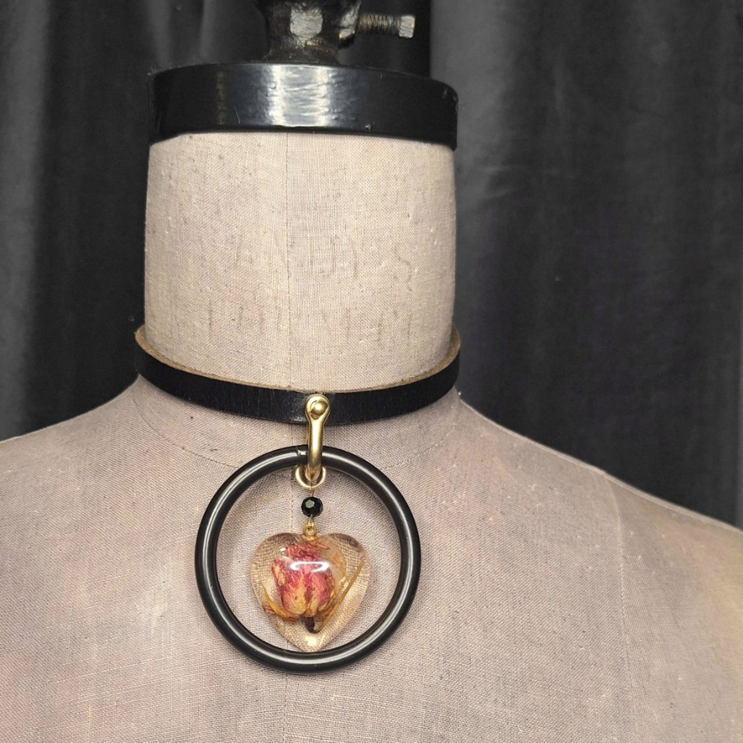 The Deadly Rose. Chic leather necklace with a single pink dried rosebud in a resin heart pendant.