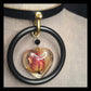 The Deadly Rose. Chic leather necklace with a single pink dried rosebud in a resin heart pendant.