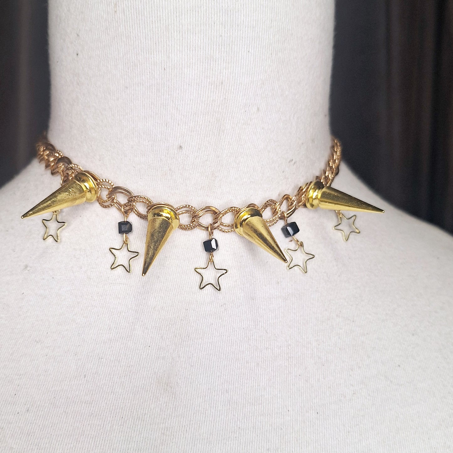 Golden Star. A celestial spiked necklace for the sophisticated punk. Subtle gold stars and jet beads. Adjustable chain closure.