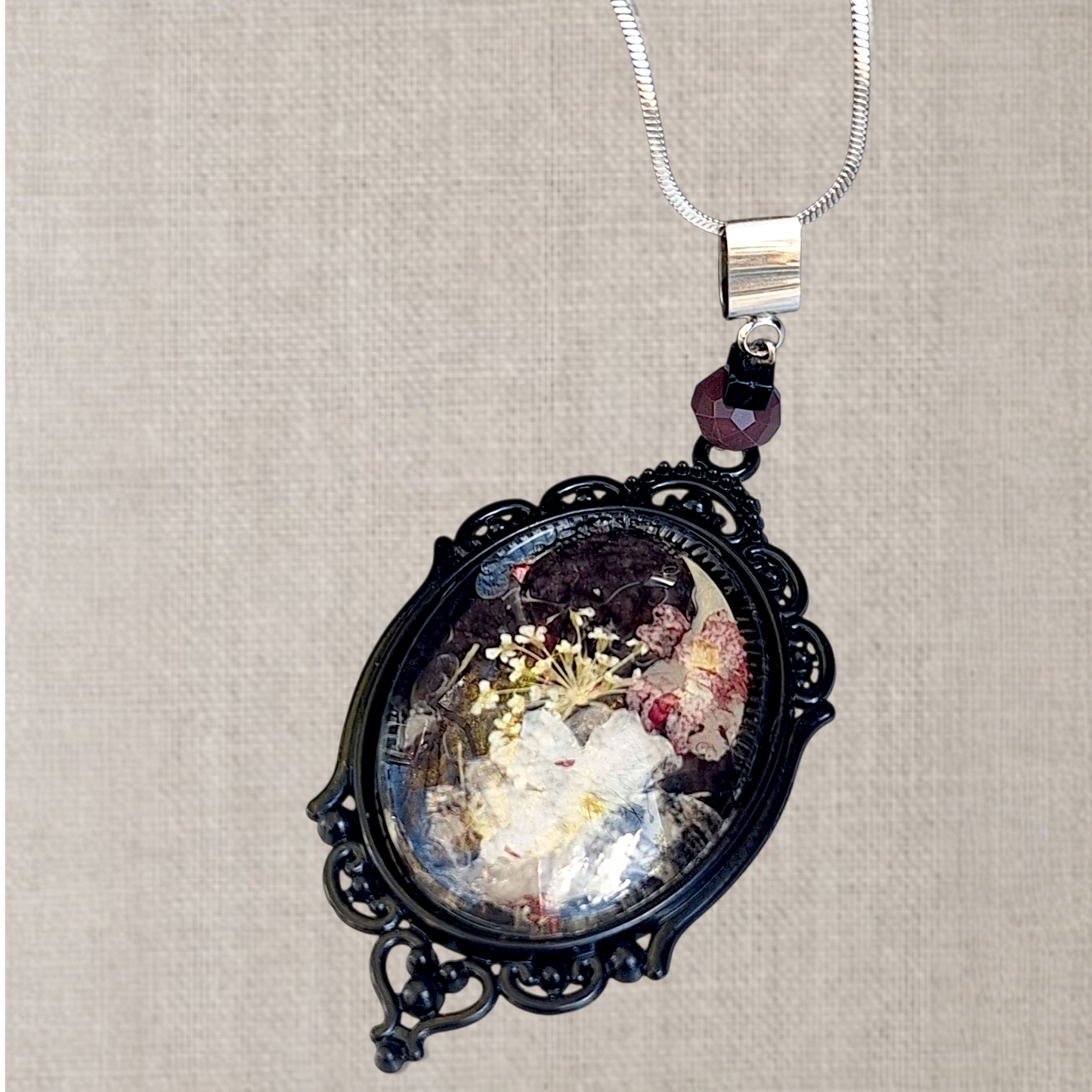 Persephone. Kinda dead, kinda alive. Statement pendant with real pressed flowers. One-of-a-kind.