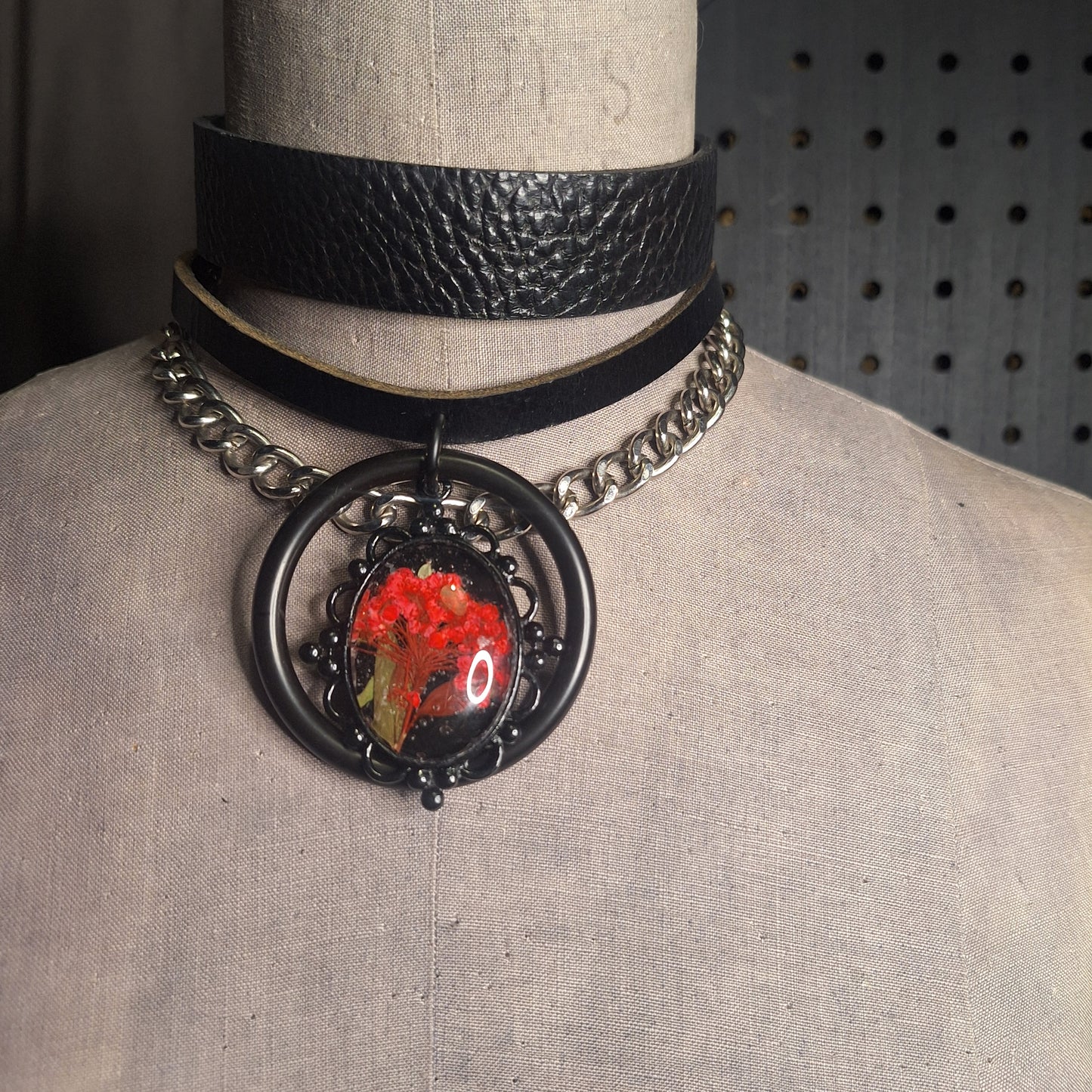 The Fire Starter. Spark your dark fem fire with this One-of-a-kind pressed flower pendant choker. Suspended in a black steel oring, off a chic black leather strip of leather. Layer it up, layer it down.