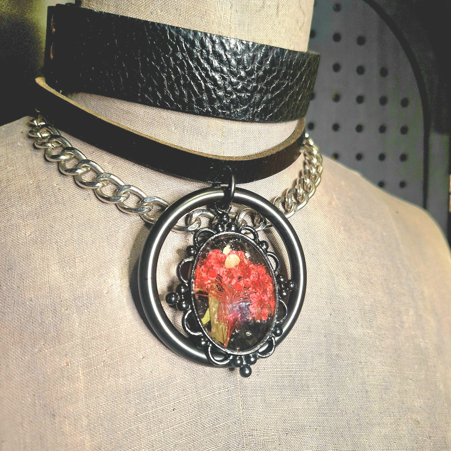 The Fire Starter. Spark your dark fem fire with this One-of-a-kind pressed flower pendant choker. Suspended in a black steel oring, off a chic black leather strip of leather. Layer it up, layer it down.