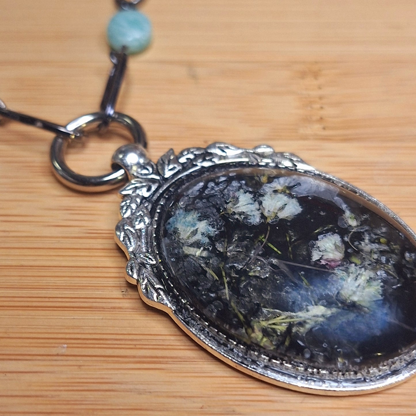 Delicate Goth Girl Pendant Necklace with babies' breath flowers in an ornate silver statement frame. Handmade. One-of-a-kind.