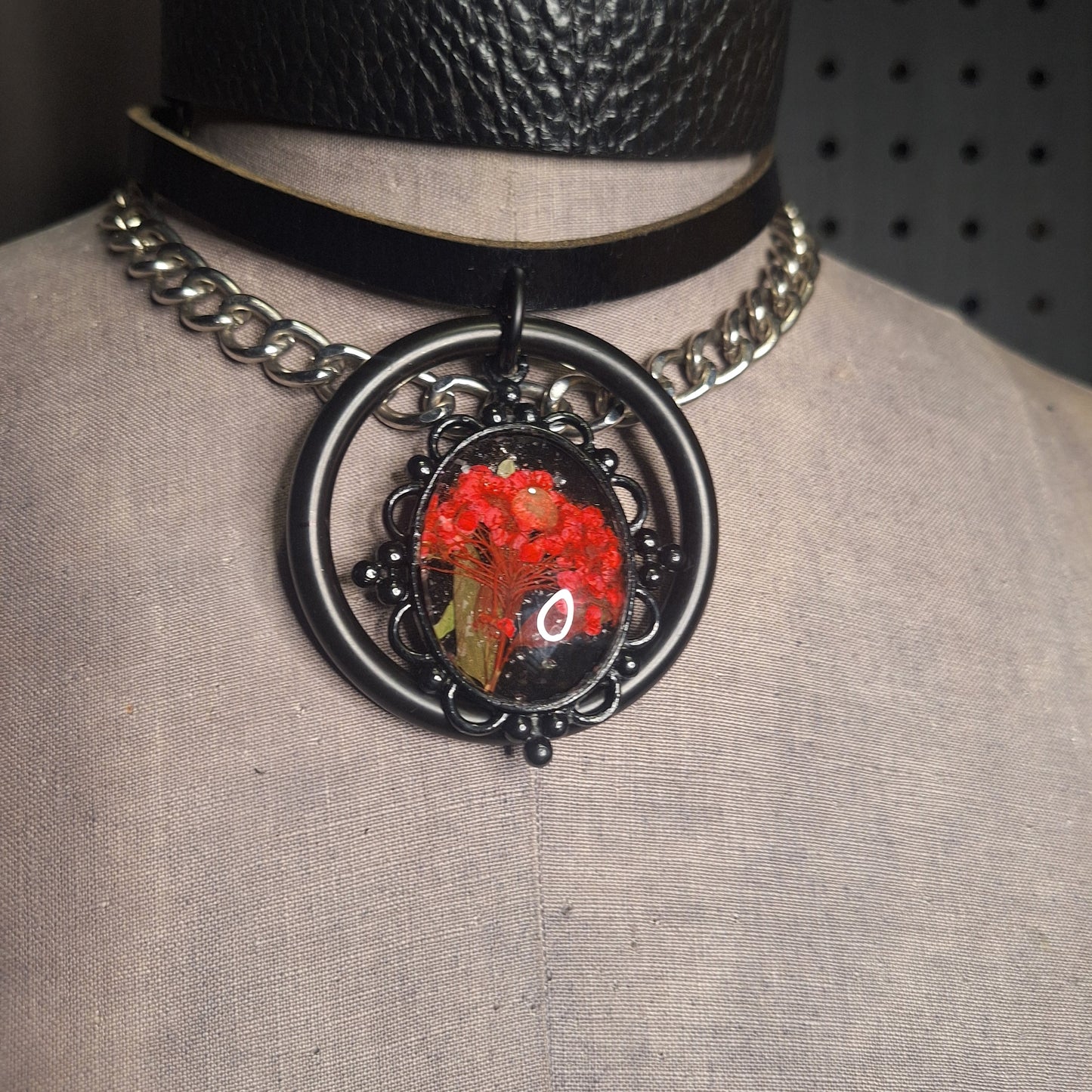 The Fire Starter. Spark your dark fem fire with this One-of-a-kind pressed flower pendant choker. Suspended in a black steel oring, off a chic black leather strip of leather. Layer it up, layer it down.