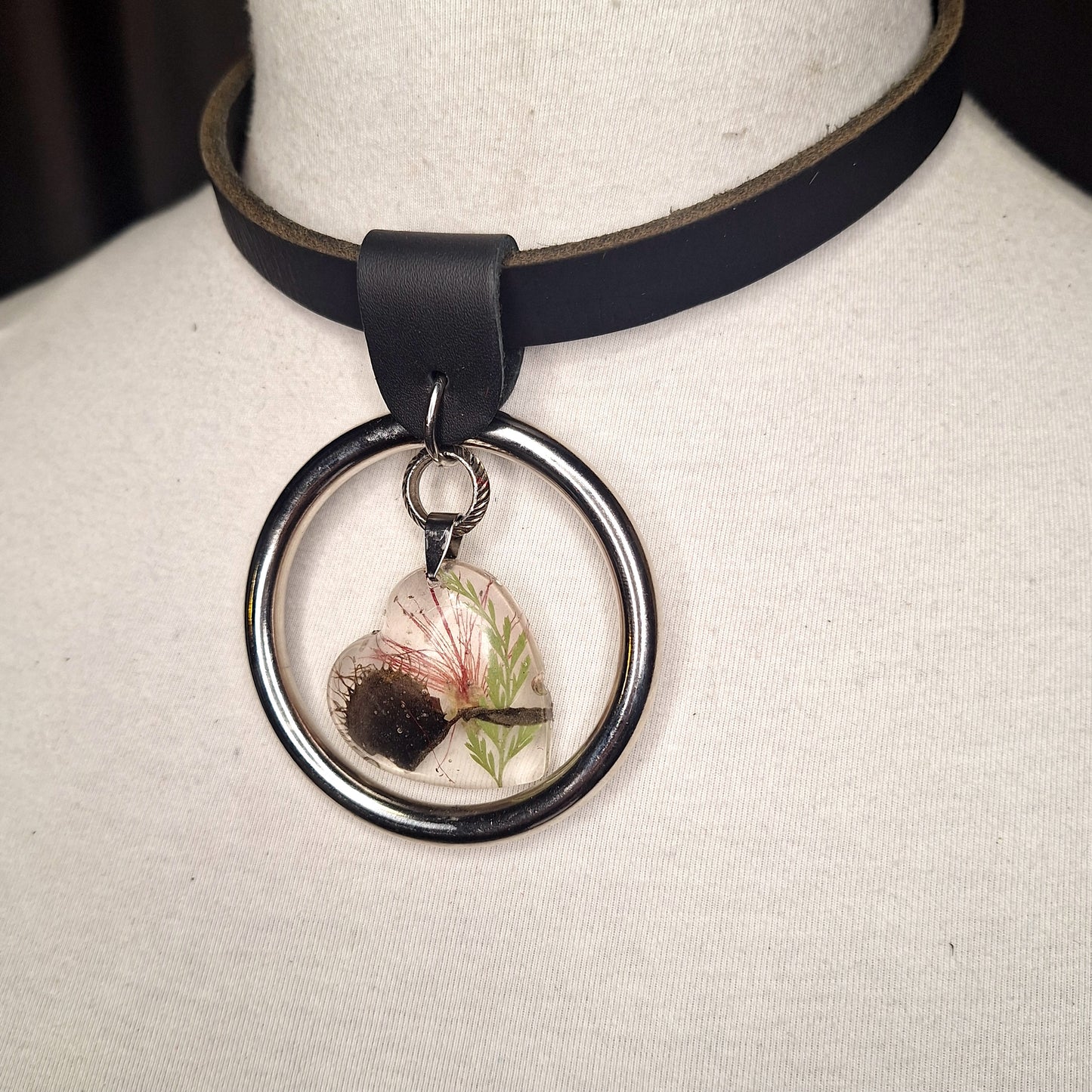 Silver O-ring leather necklace with Venus Fly Trap resin heart shaped pendant.