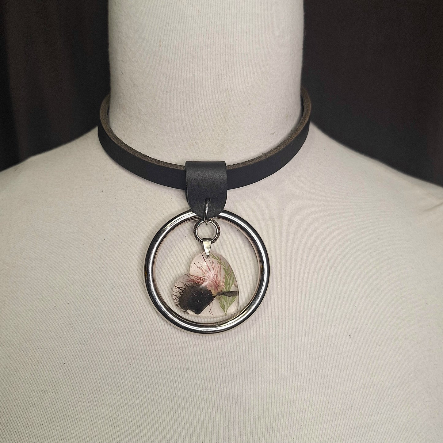 Silver O-ring leather necklace with Venus Fly Trap resin heart shaped pendant.