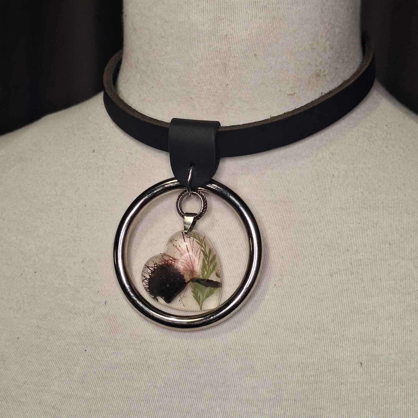 Silver O-ring leather necklace with Venus Fly Trap resin heart shaped pendant.