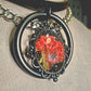 The Fire Starter. Spark your dark fem fire with this One-of-a-kind pressed flower pendant choker. Suspended in a black steel oring, off a chic black leather strip of leather. Layer it up, layer it down.