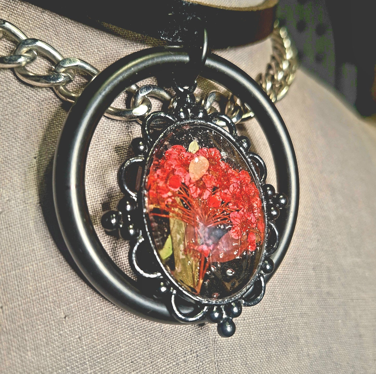 The Fire Starter. Spark your dark fem fire with this One-of-a-kind pressed flower pendant choker. Suspended in a black steel oring, off a chic black leather strip of leather. Layer it up, layer it down.