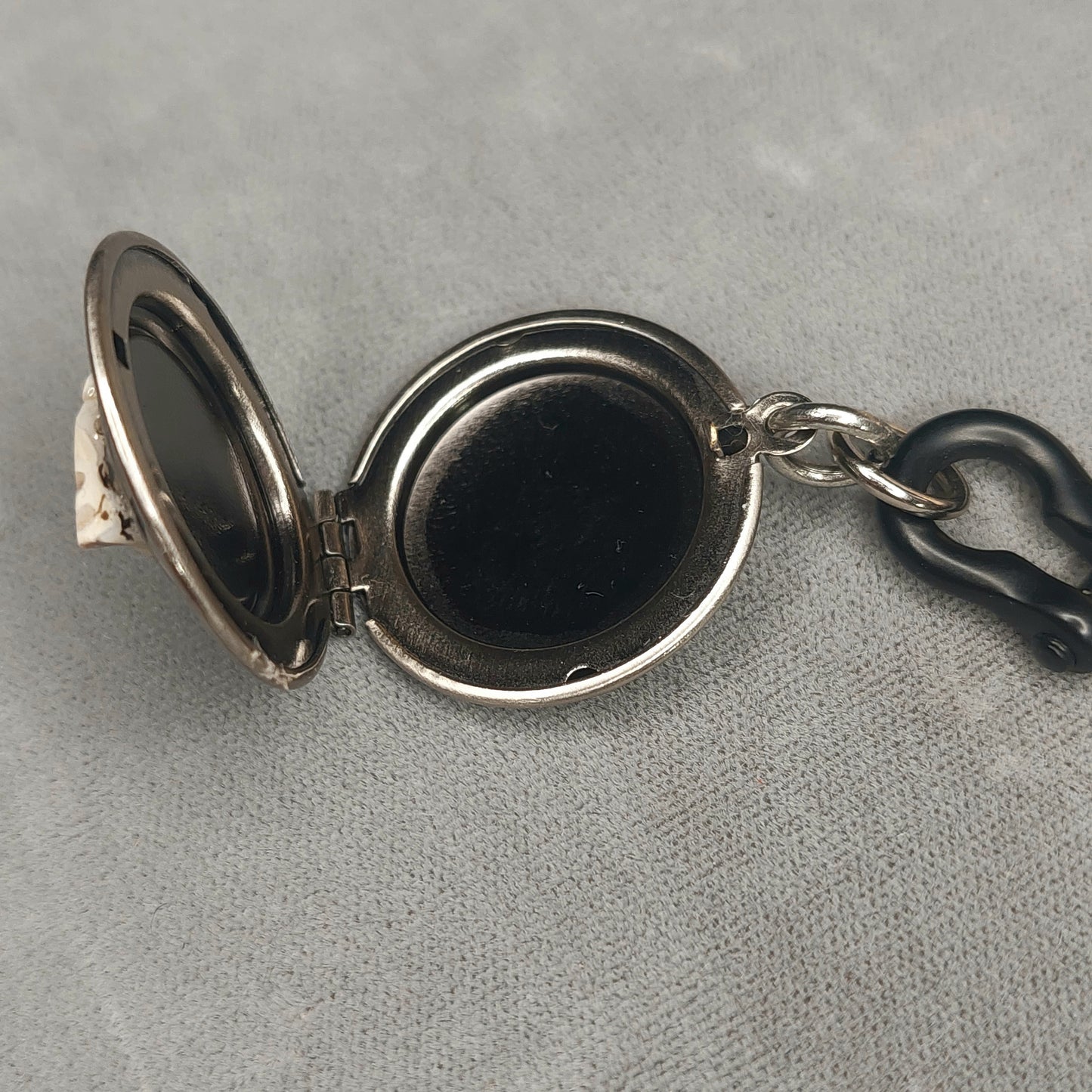 Silver locket tooth pendant with black steel shackle pin.