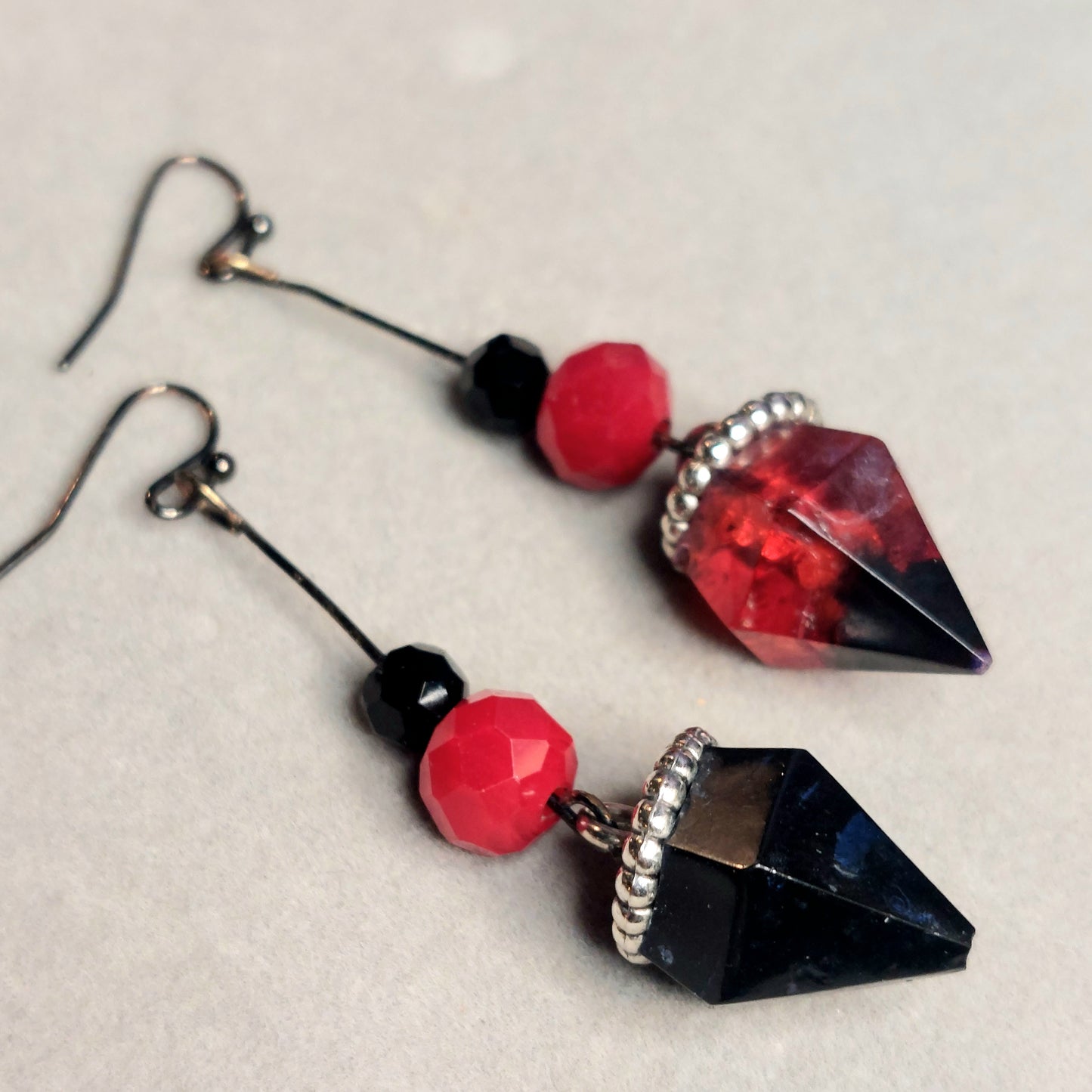 Red and black jewel shaped earrings.