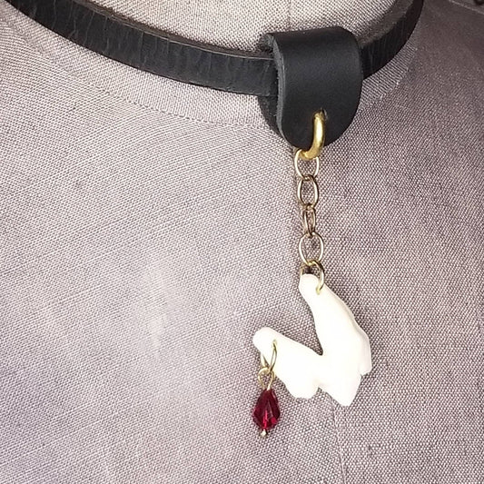 Coyote tooth charm with red blood drop crystal.